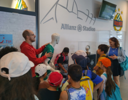 Einige Kinder stehen in der Eingangshalle des Allianzstadion. 