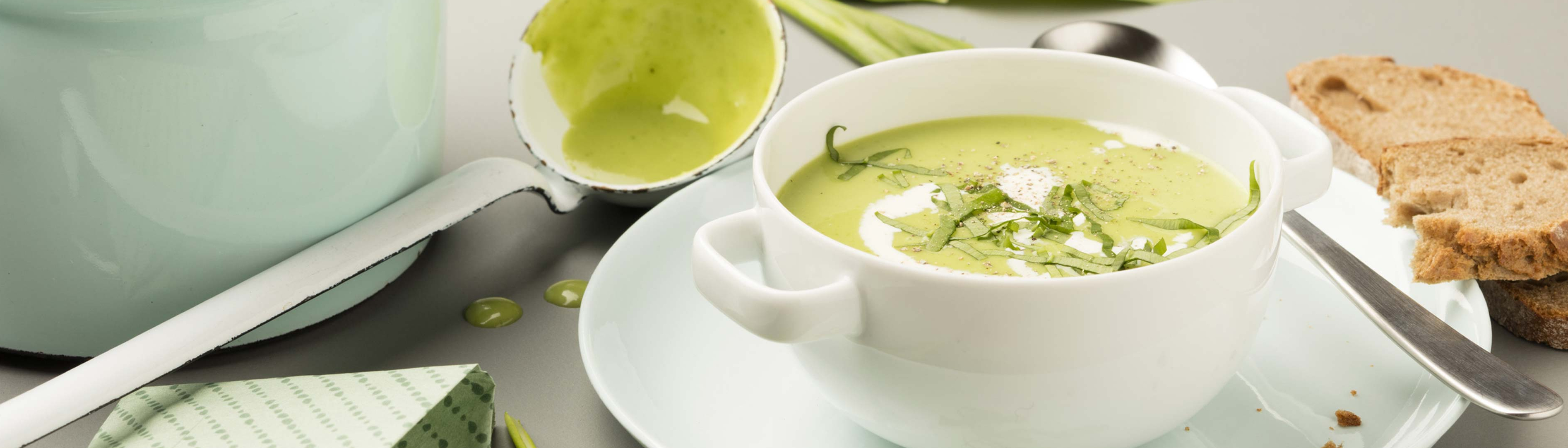 Essen auf Rädern grüne Cremesuppe auf Teller angerichtet
